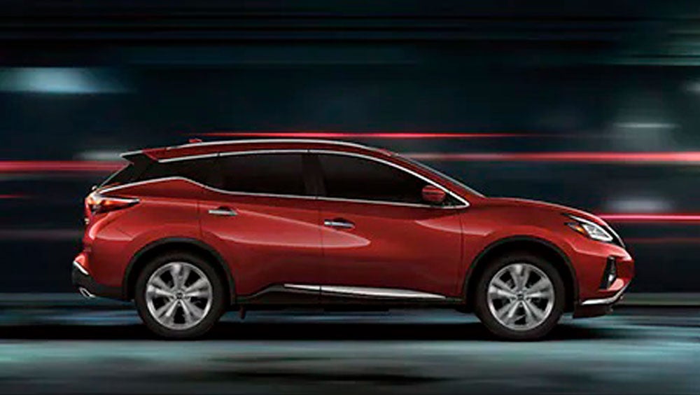 2023 Nissan Murano shown in profile driving down a street at night illustrating performance. | Nissan of St. Augustine in St. Augustine FL