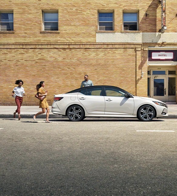 2023 Nissan Sentra parked in front of hotel to illustrate fleet program.