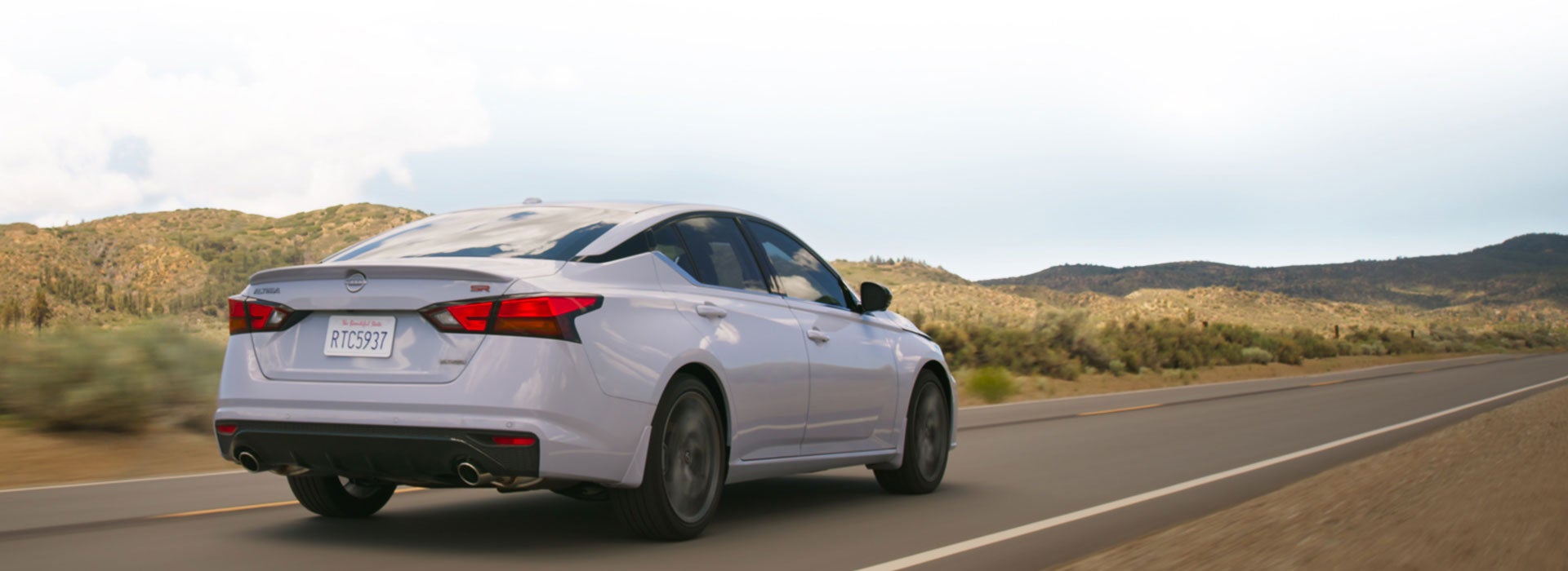 Nissan Altima driving on an open highway